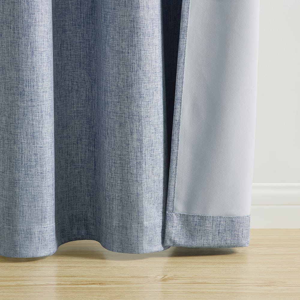 The hem of a Fairfax Blue panel turned back to show its white blackout backing