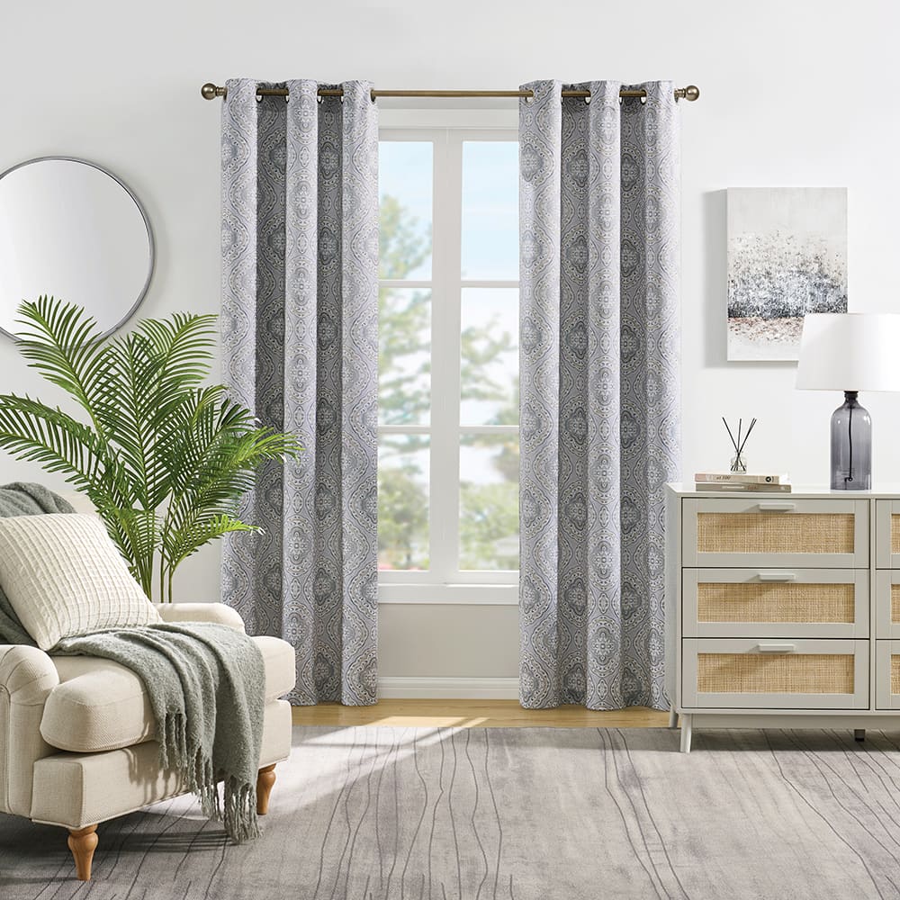 Camilla room darkening curtains in blue at a window in a furnished room