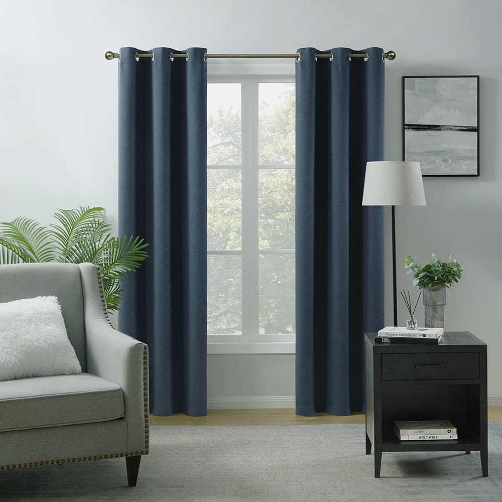 Navy Chelsea room darkening curtains at a window beside an armchair