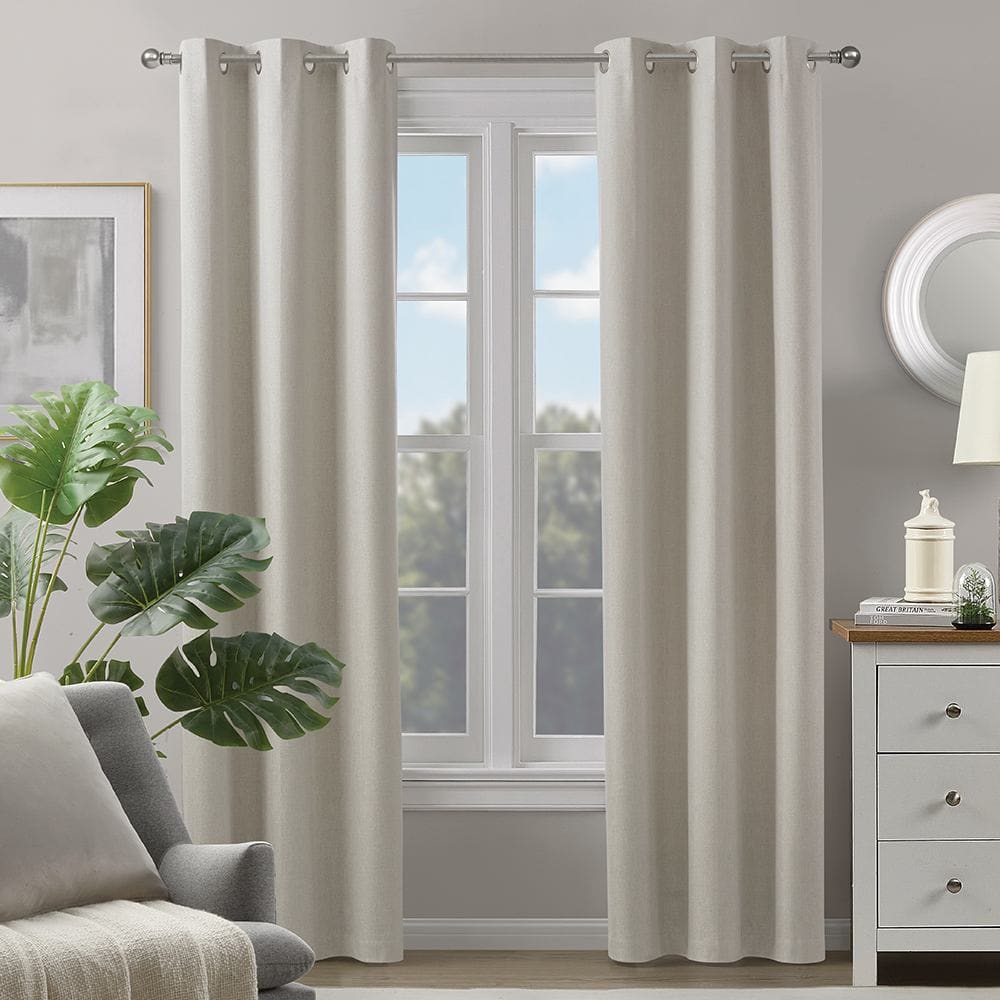 Fairfax 100% blackout panels in ivory at a bright window, an armchair and a white side table