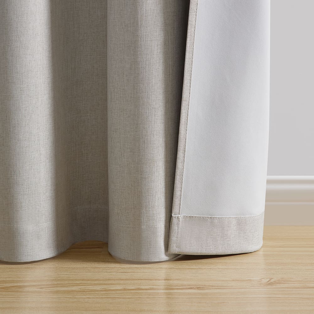 The hem of an ivory Fairfax panel turned back to show the white back behind the woven face