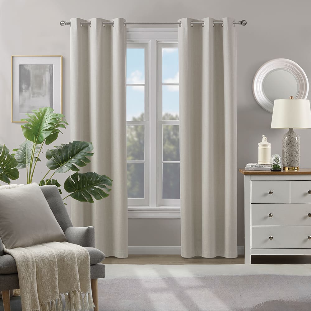 Fairfax 100% blackout curtains in ivory at a window in a furnished room