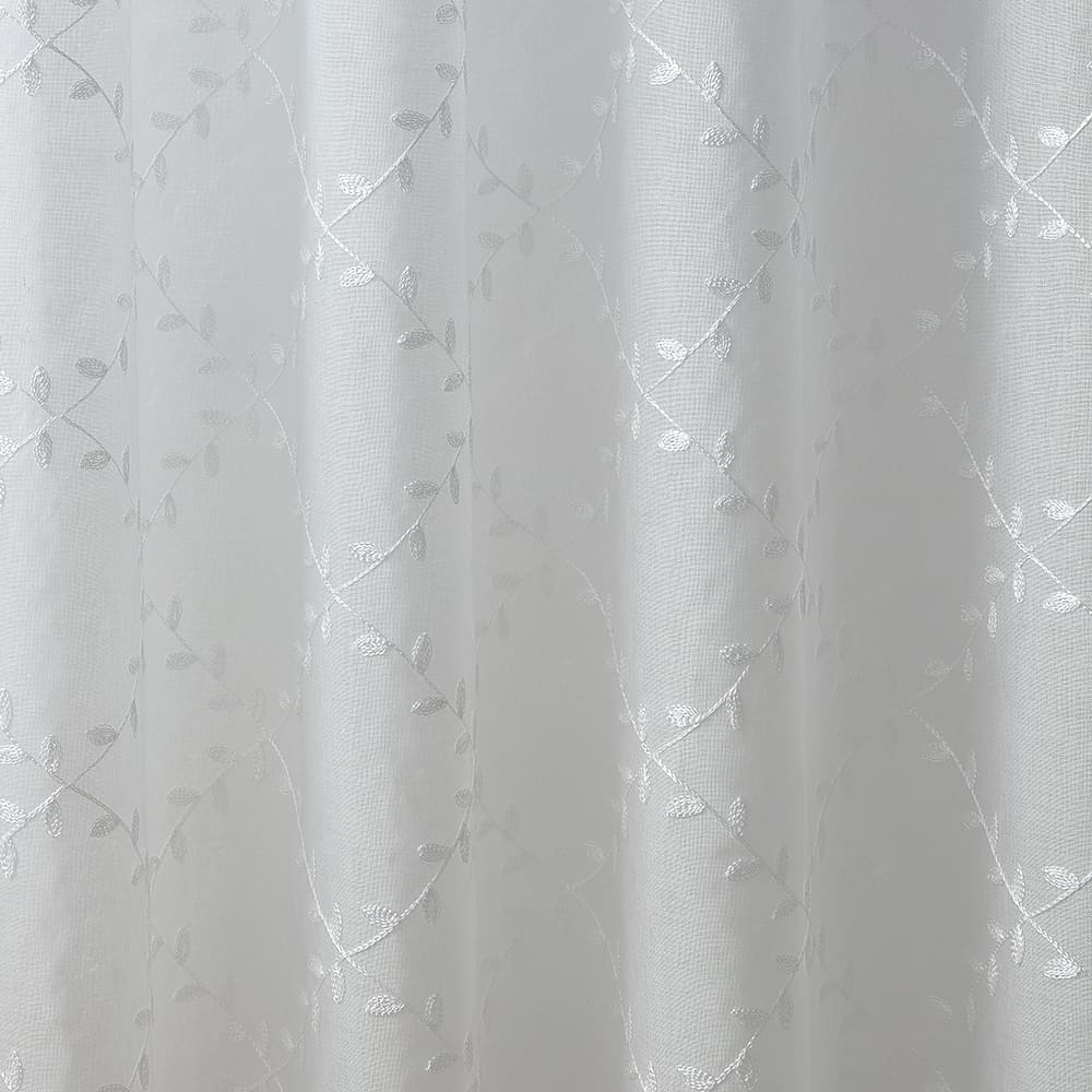 The folds of a Leaf Embroidery white panel, close up