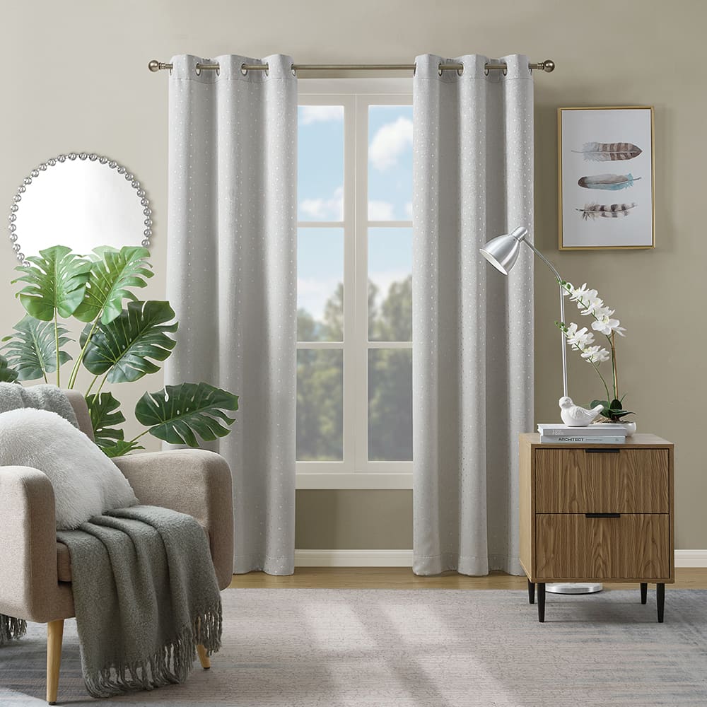 Marquee blackout curtains in grey with silver foil at a window in a furnished room