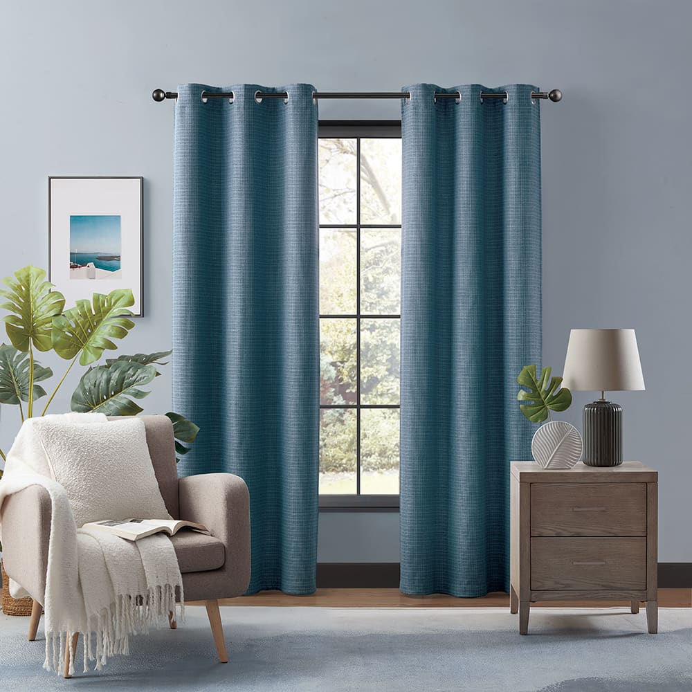 Morgan room darkening curtains in blue at a window in a furnished room