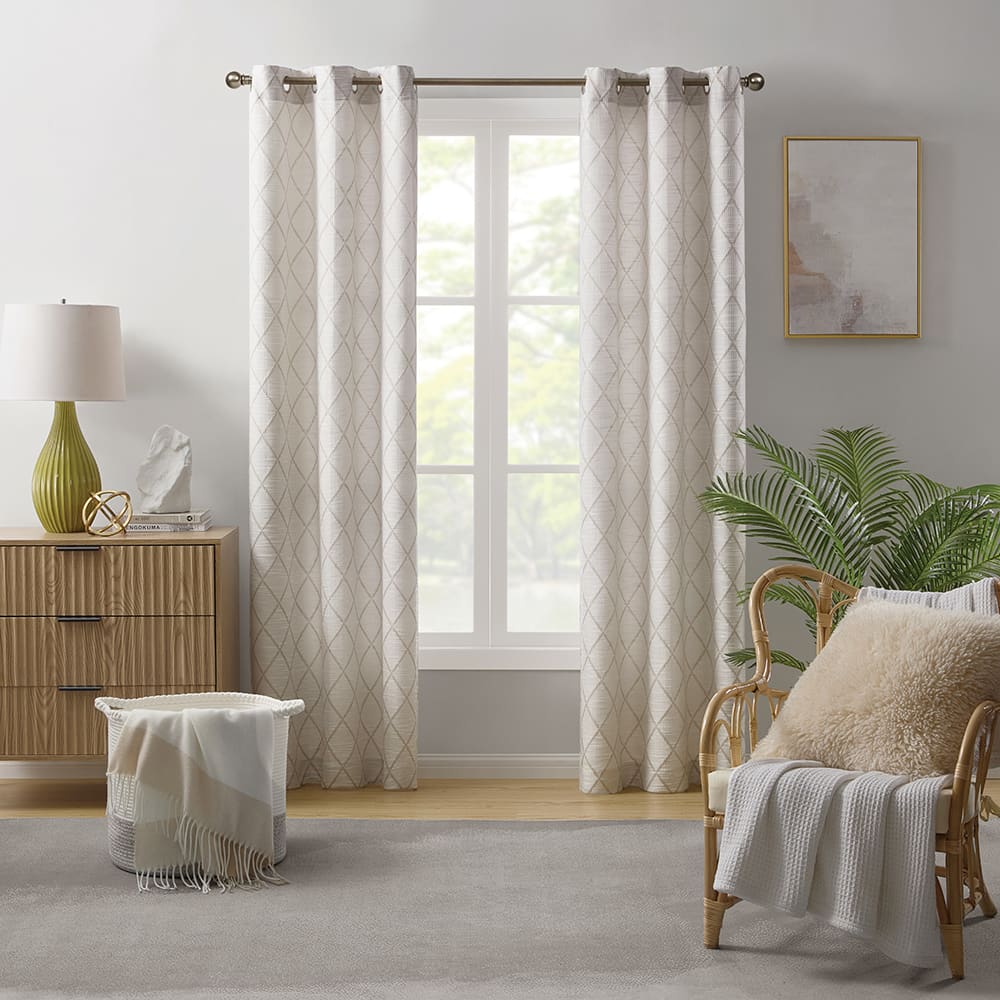 Orion light filtering curtains in natural at a window in a furnished room