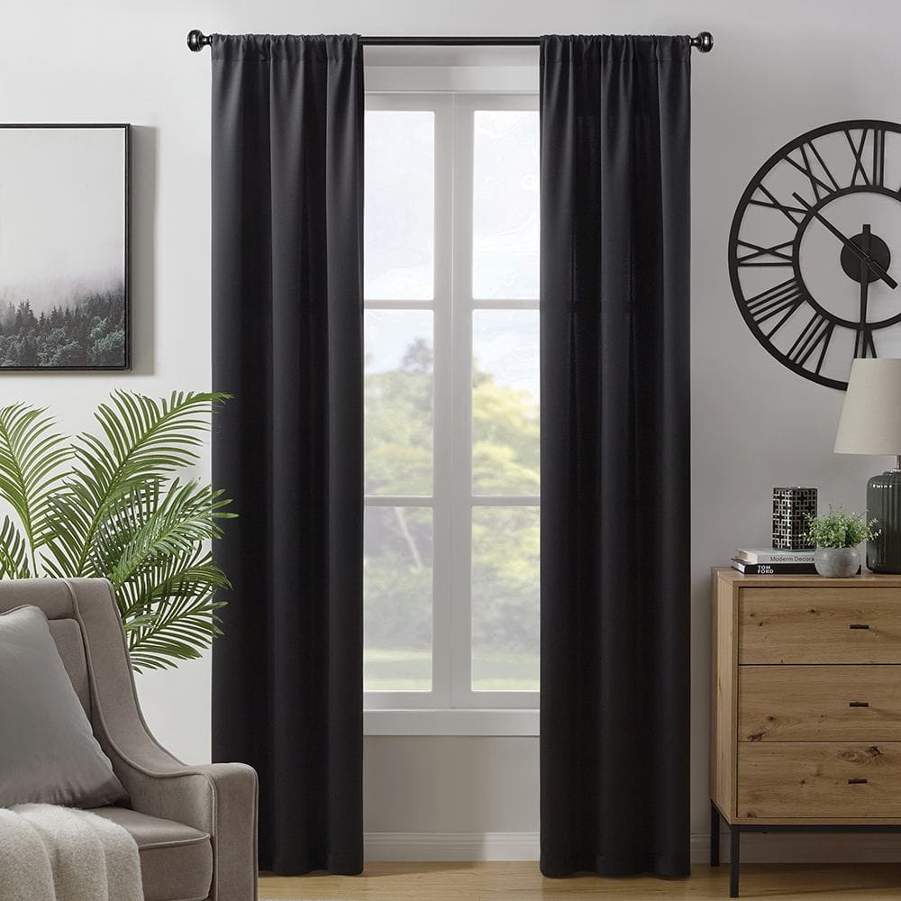 Savoy room darkening panels in black at a window beside an armchair
