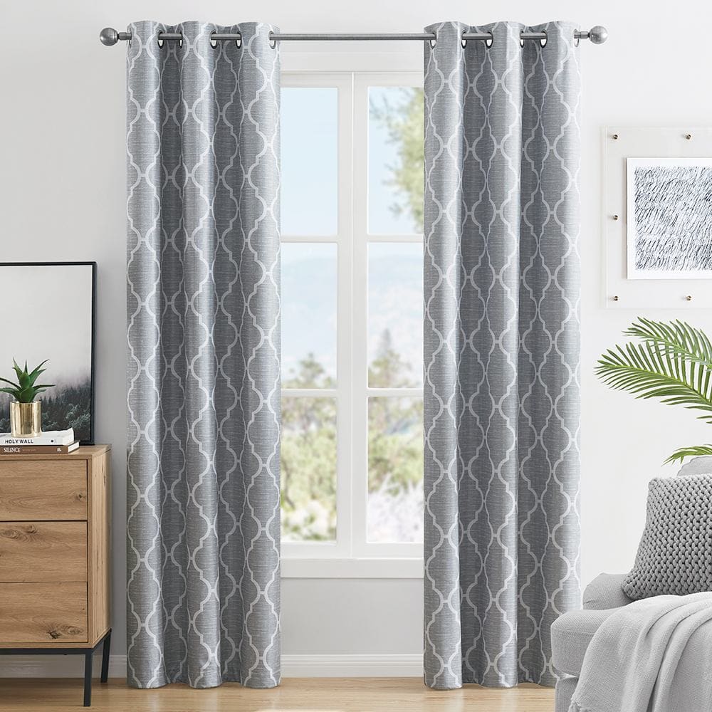 Trellis 100% blackout panels in grey with a white lattice print at a window