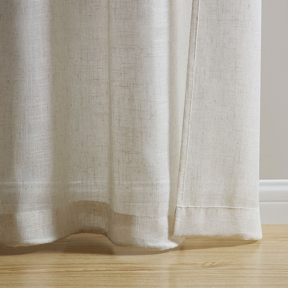 The bottom of a Valencia natural linen blend panel where it meets the floor